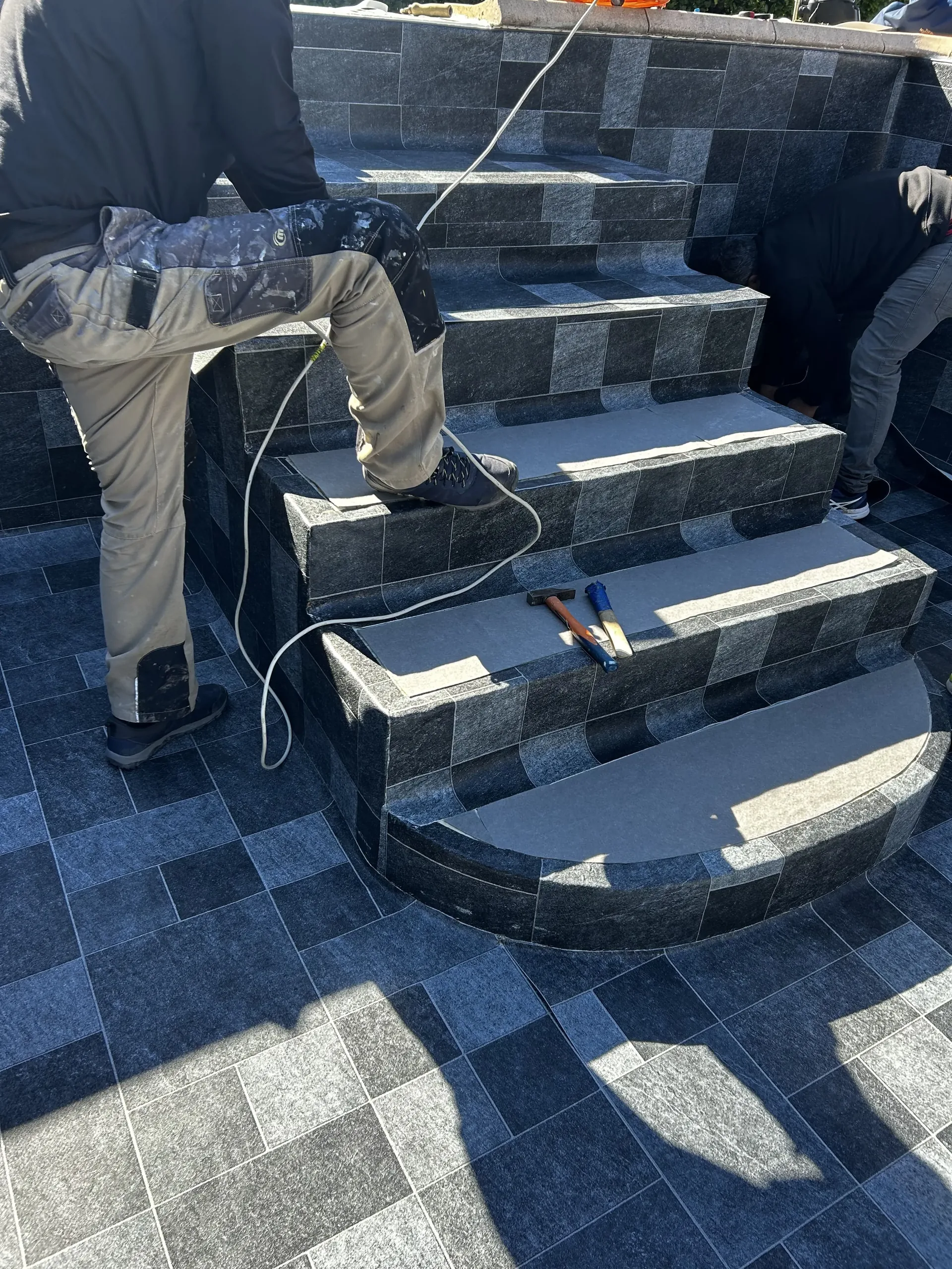 Pose en cours du revêtement PVC armé 3D Bali sur escaliers — STAFF Piscines
